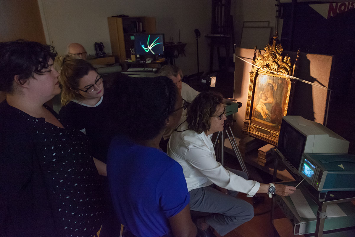 Morgan Shedd, Megan Mezara, and Aleyah Grimes perform IR imaging of a painting with Carol Sawyer, Senior Paintings Conservator.”
